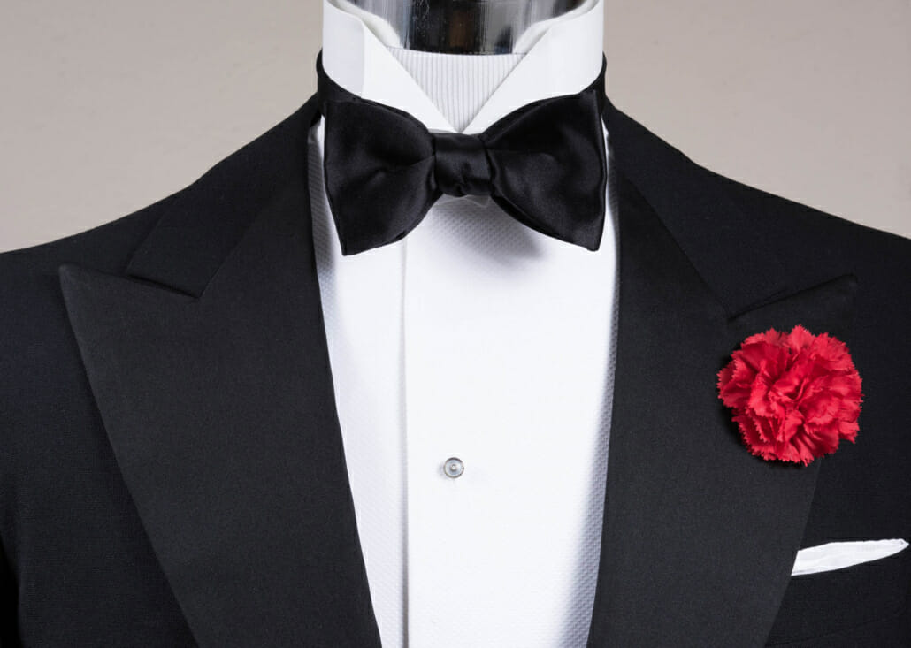 Black tie formalwear with a red carnation